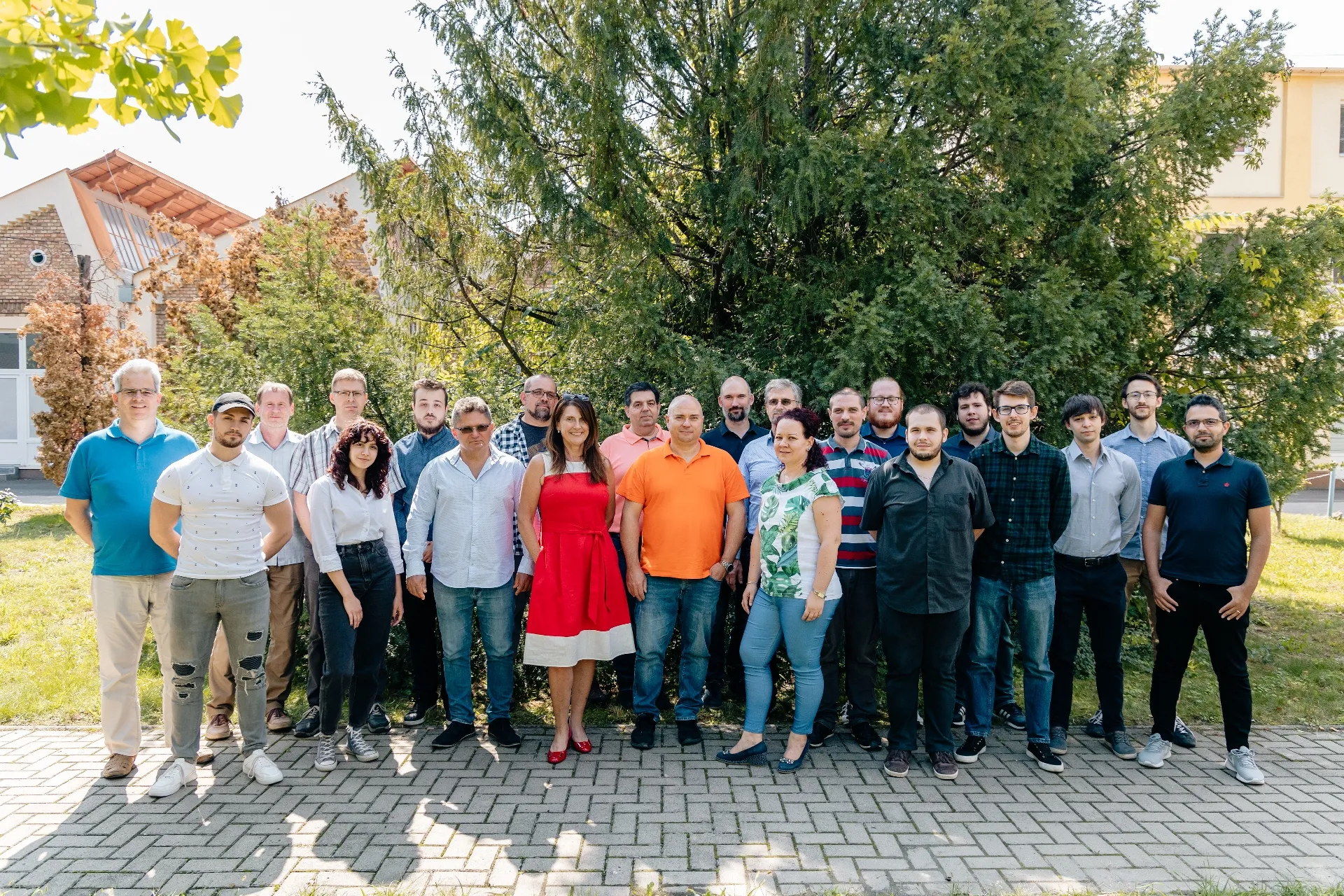 A Bitotron csapata 2022-ben: a fejlesztők egy napsütötte udvaron, nagy fa előtt állnak csoportképhez.